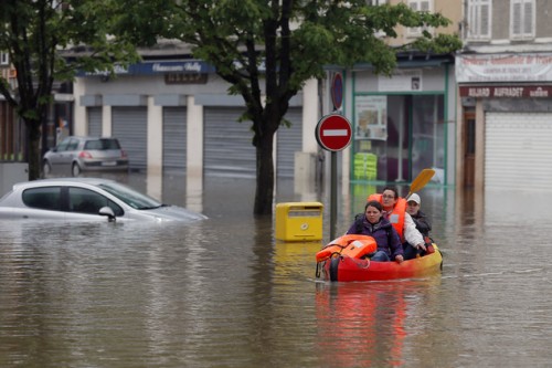 Residents use a canoe to evacuate in downtown Nemours, 50 miles south of Paris, Thursday, June 2, 2016. Floods inundating parts of France and Germany have left five people reported dead and thousands trapped in homes or cars, as rivers have broken their banks from Paris to Bavaria. (AP Photo/Francois Mori)